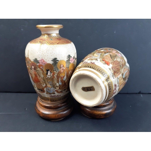 188 - A beautiful little pair of older Japanese SATSUMA vases on wooden bases.  Each standing 12cm high ap... 