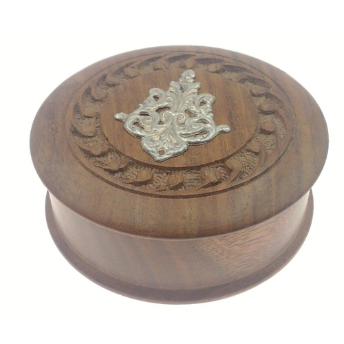 26 - A small wooden box (9cm dia approx) with white metal motif to top contents with a 925 silver marcasi... 