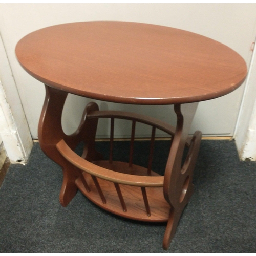 347 - A wooden oval shaped side table 60x40x55cm with a lower shelf behind bars.#364