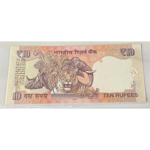 176 - A Numis banknote album containing a substantial collection of RESERVE BANK OF INDIA Ghandi notes in ... 