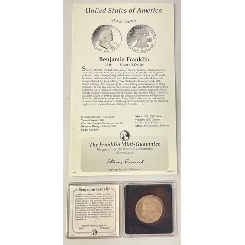 206 - A Franklin Mint folder containing two UNITED STATES Silver Half Dollars in holders with paperwork.  ... 