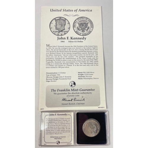 206 - A Franklin Mint folder containing two UNITED STATES Silver Half Dollars in holders with paperwork.  ... 