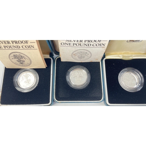 239 - Three boxed ROYAL MINT United Kingdom silver proof one pound coins from 1984, 85 and 86#239