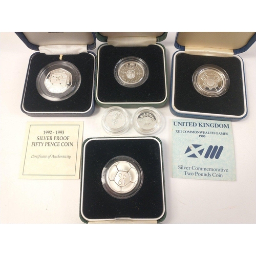 246 - Six ROYAL MINT silver proof coins to include a 1986 XIII Commonwealth Games £2 coin, 1992-93 50pence... 