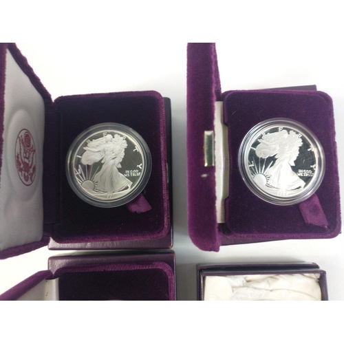 247 - Four boxed SILVER ONE OUNCE PROOF AMERICAN EAGLES in boxes with interior plush cases. 1986, 1989, 19... 