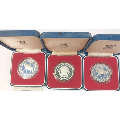 255 - Three 1977 Silver Crown coins in cases with coa to include FALKLAND ISLANDS Fifty Pence and two 1977... 