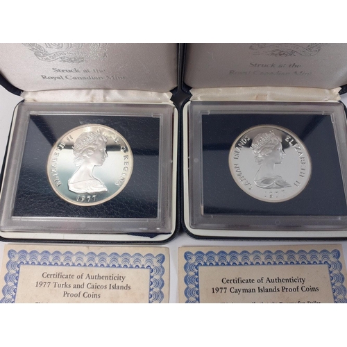 324 - Two proof slabbed and cased 1977 QUEENS SILVER JUBILEE coins to include Cayman Islands $25 and Turks... 