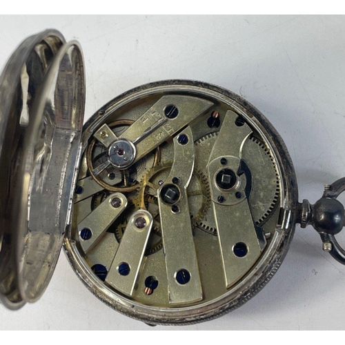 404 - A silver pocket watch, stamped 935, with floral design at centre of the face which measures approx 4... 