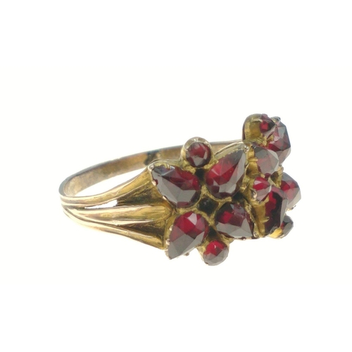 444 - STUNNING! An UNMARKED yellow metal floral design red stone set ring Size U, gross weight 3.45g#81... 