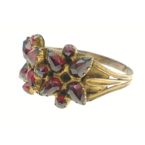 444 - STUNNING! An UNMARKED yellow metal floral design red stone set ring Size U, gross weight 3.45g#81... 