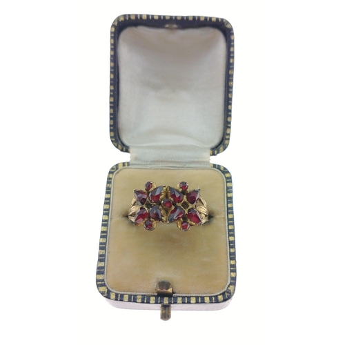 444 - STUNNING! An UNMARKED yellow metal floral design red stone set ring Size U, gross weight 3.45g#81... 