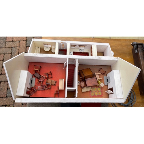 567 - A VINTAGE dolls house with removable roof and side section with furniture and lights (lights and ele... 