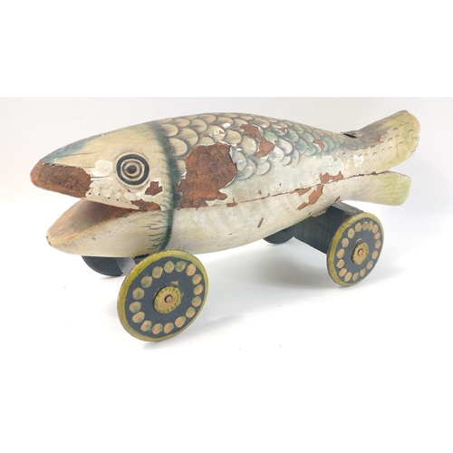 722 - A highly unusual hand-made wooden pull-along fish complete with 2 compartments inside for hiding tre... 