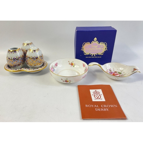 199 - A ROYAL CROWN DERBY tea strainer and drip bowl in original box with a small condiment set#202