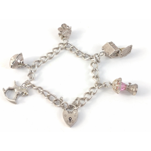 31 - A lovely little sterling silver charm bracelet with some articulated charms.  Chain linked are indiv... 