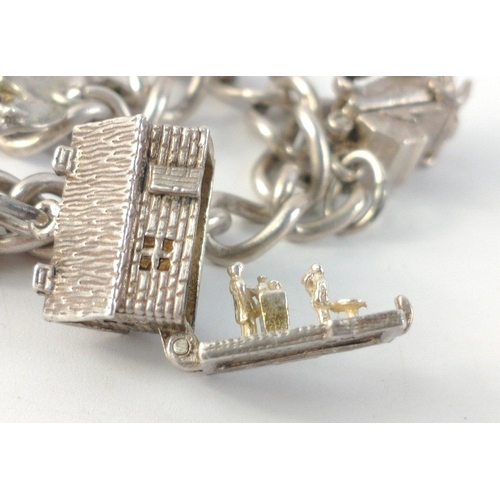 31 - A lovely little sterling silver charm bracelet with some articulated charms.  Chain linked are indiv... 