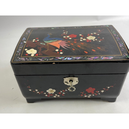 42 - An OPULENT ORIENTAL lacquered wind-up jewellery box with a peacock-form bird handpainted on the top ... 