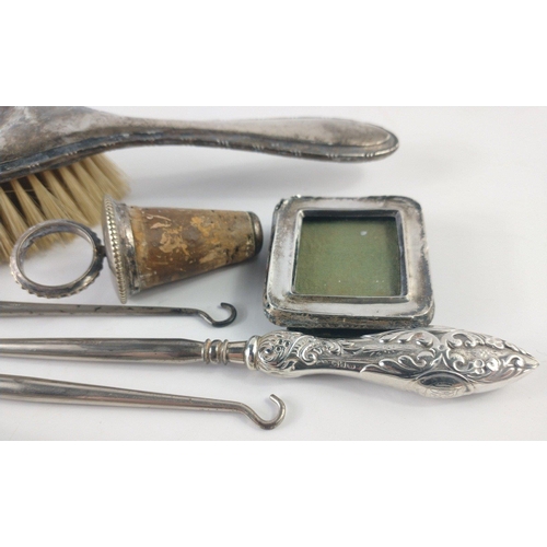 206 - A mixed lot of mainly Hallmarked silver items to include three hallmarked handled button hooks and a... 