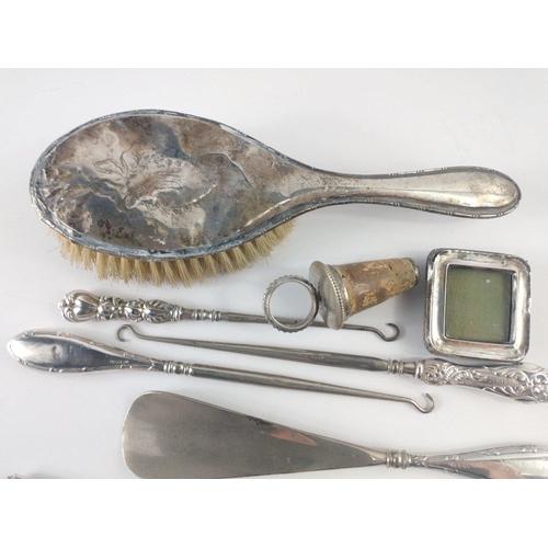 206 - A mixed lot of mainly Hallmarked silver items to include three hallmarked handled button hooks and a... 