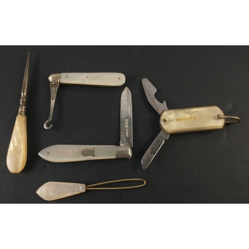 209 - A vintage dressing set with mother of pearl handles to include a hallmarked button hook and fruit kn... 