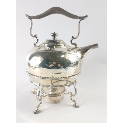 221 - An EPNS spirit kettle on four flat iron feet with complete burner and ebonised handle, stands approx... 