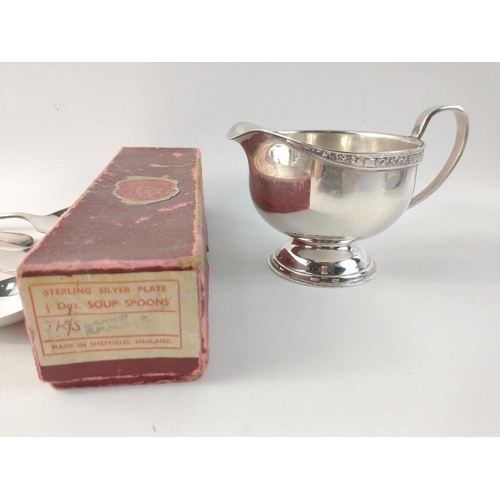 222 - EPNS.  A box of six useful Sheffield plate soup spoons and a small plated sauce boat.#221