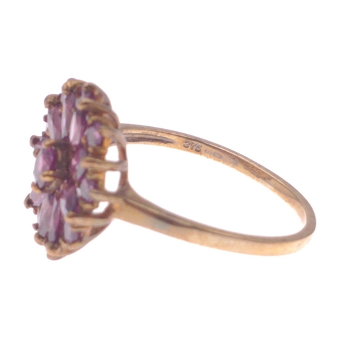 46 - A ring, stamped 375, set in a floral design with purple stones, size P, gross weight2.90g approx#46... 