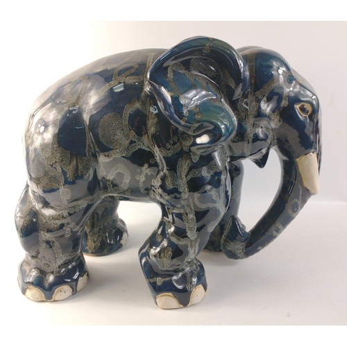 138 - An unusually attractive pair of ceramic elephants glazed in colours of blue/grey/black with random g... 