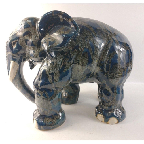 138 - An unusually attractive pair of ceramic elephants glazed in colours of blue/grey/black with random g... 