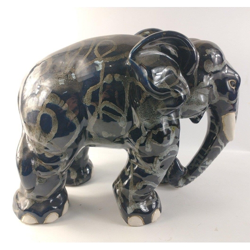 138 - An unusually attractive pair of ceramic elephants glazed in colours of blue/grey/black with random g... 