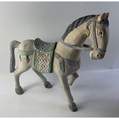 160 - A carved wooden horse in the style of the Chinese terracotta army, stands 45cm tall.  It has sustain... 