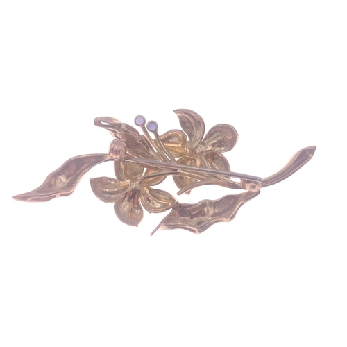 13 - A floral brooch hallmarked 18ct gold set with 3 small blue stones, 6cm long approx, gross weight 9.7... 