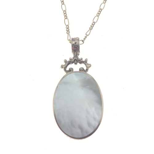 20 - A double-sided mother of pearl and silver hallmarked pendant (3cm long) on a 375 stamped chain (54cm... 