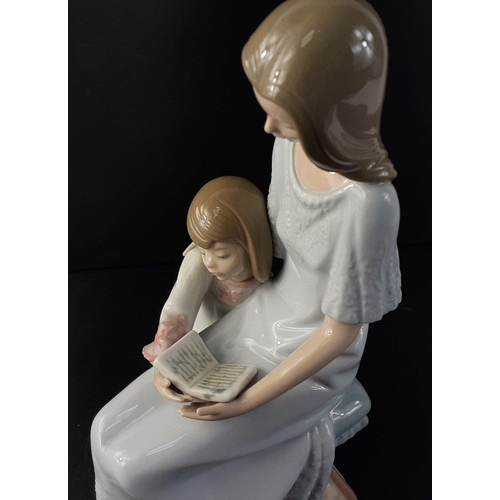 325 - A LLADRO figurine of a lady and child reading from 1987 stands 27cm high, no cracks, chips or visibl... 