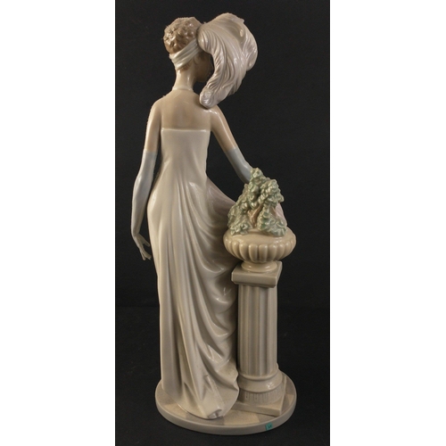 329 - A beautiful LLADRO 1920s female figurine in flowing gown standing next to classical column and vase ... 