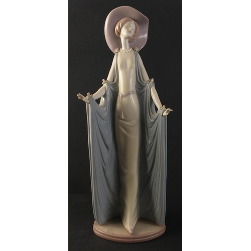 330 - A beautiful tall LLADRO figure of a svelte female in hat and flowing gown. Handmade in timelessly co... 