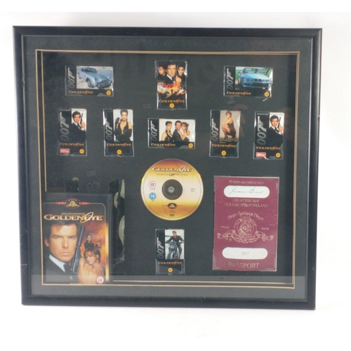 275 - James Bond GOLDENEYE collage of DVD, passport facsimile, phone cards all within a frame measuring 55... 