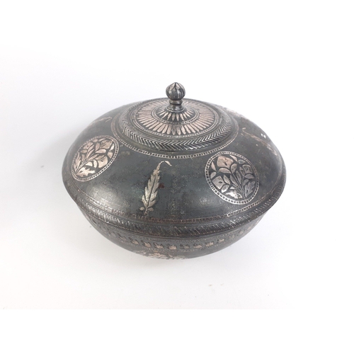 198 - An Indian BIDRI style lidded medicine bowl with silver inlay.  Measures 130mm diameter approx and st... 