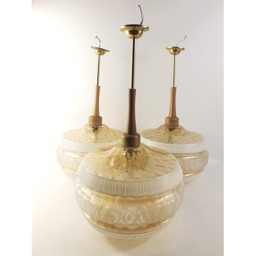 390 - A set of 3 pre-owned 70s-style blown glass-based ceiling lamps with brass and wood fittings. Approx.... 