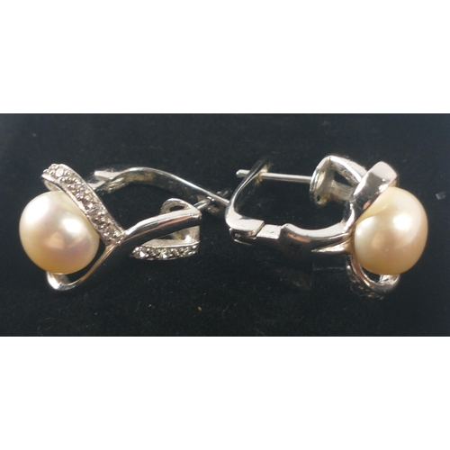 59 - A pair of quality earrings stamped 925 set with a pearl and clear white stones gross weight 7.4g app... 