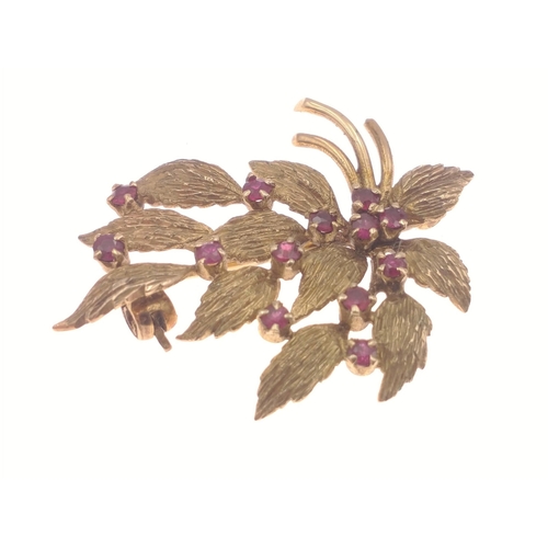 11 - A very pretty pin brooch with 375 stamp on rear. Studded with 12 garnets in floral form  Total gross... 