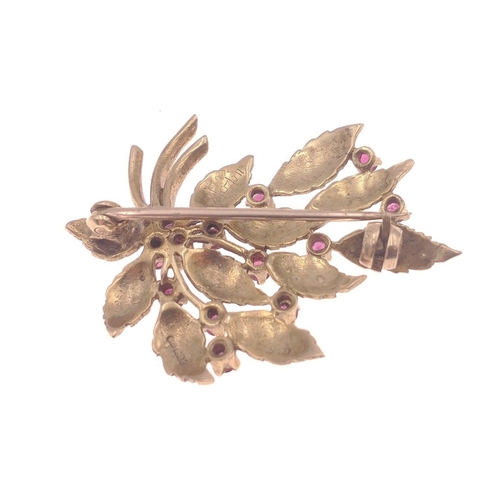 11 - A very pretty pin brooch with 375 stamp on rear. Studded with 12 garnets in floral form  Total gross... 