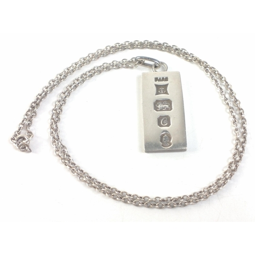 111 - A silver ingot pendant on a sterling marked chain fully hallmarked for 1977 Birmingham with Elizabet... 