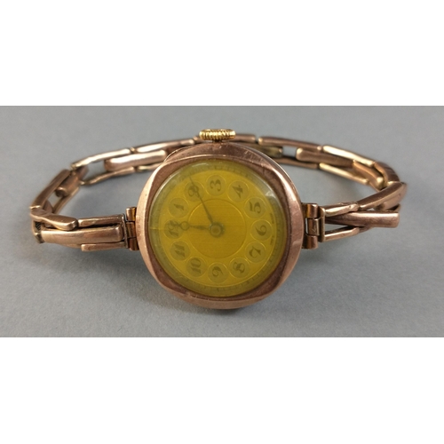 20 - A 9ct gold cased ladies cocktail watch.  9ct marks to centre bands of the bracelet.  Watch not curre... 