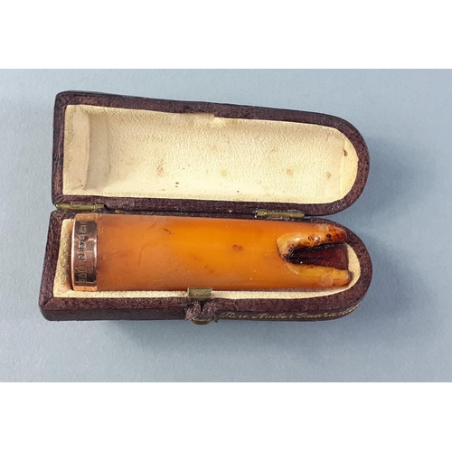 4 - A vintage gold 375 hallmarked cigarette holder in a custom leather case with 'Pure Amber Guaranteed'... 