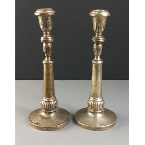 57 - A pair of silver candlesticks each stamped 900 with  unweighted bases.  Each stands 26cm tall, combi... 