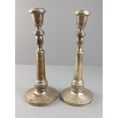 57 - A pair of silver candlesticks each stamped 900 with  unweighted bases.  Each stands 26cm tall, combi... 