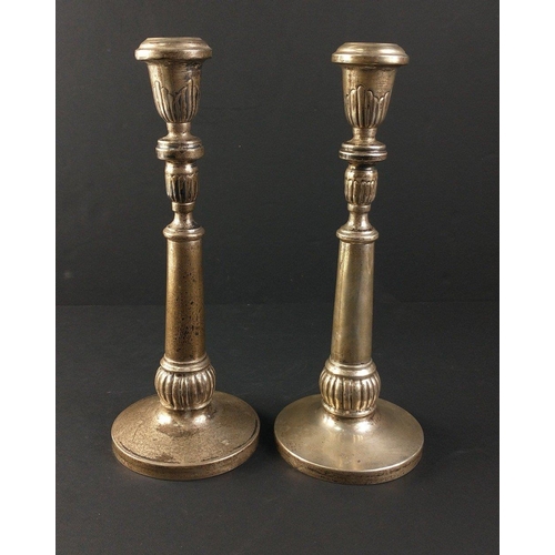 57 - A pair of silver candlesticks each stamped 900 with  unweighted bases.  Each stands 26cm tall, combi... 