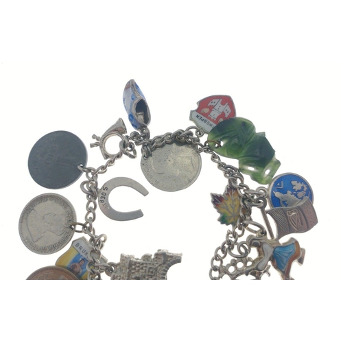 95 - Silver charm bracelet with Victorian silver coins attached and others. Total gross weight 30g approx... 