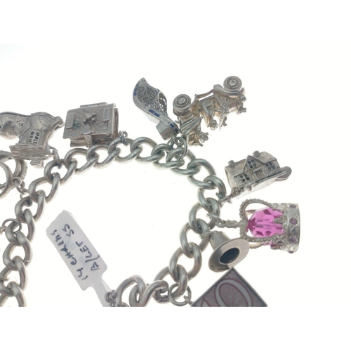 98 - Silver charm bracelet with multiple charms many articulated. Total gross weight 86.5g approx.#107... 